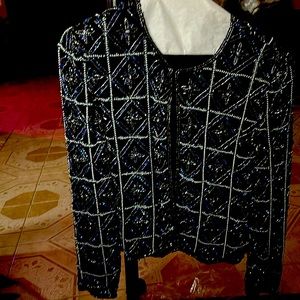 Black jacket with blue and silver sequins. Lined and long sleeves